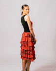 Side profile of model wearing the sleeveless black Lauren Heart Top in Overland Sigh print paired with a matching red-orange skirt.