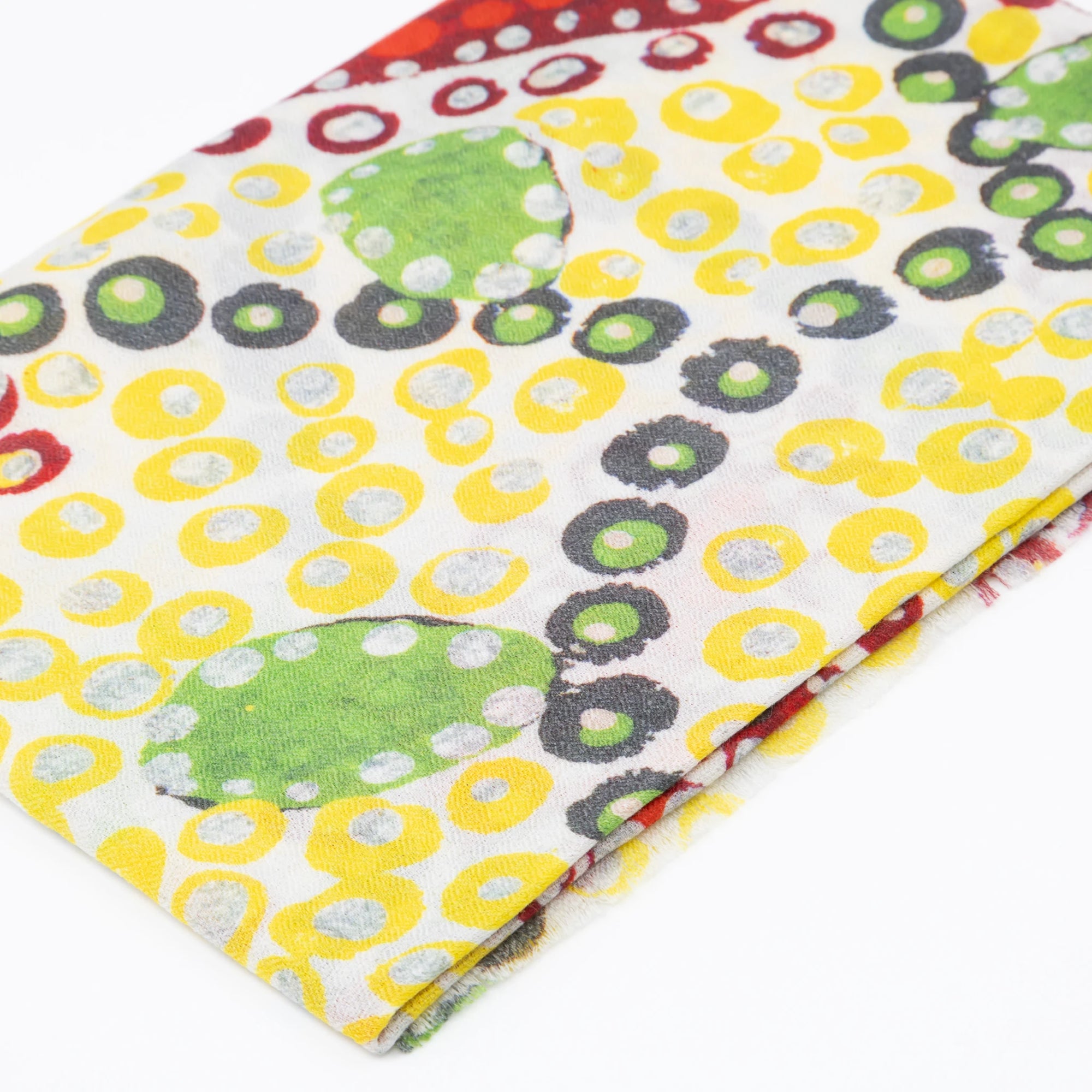 Close-up of the Blooming Sturt Peas cashmere scarf showing soft textile weave, warm golden tones, and detailed Pilbara Sturt pea artwork.