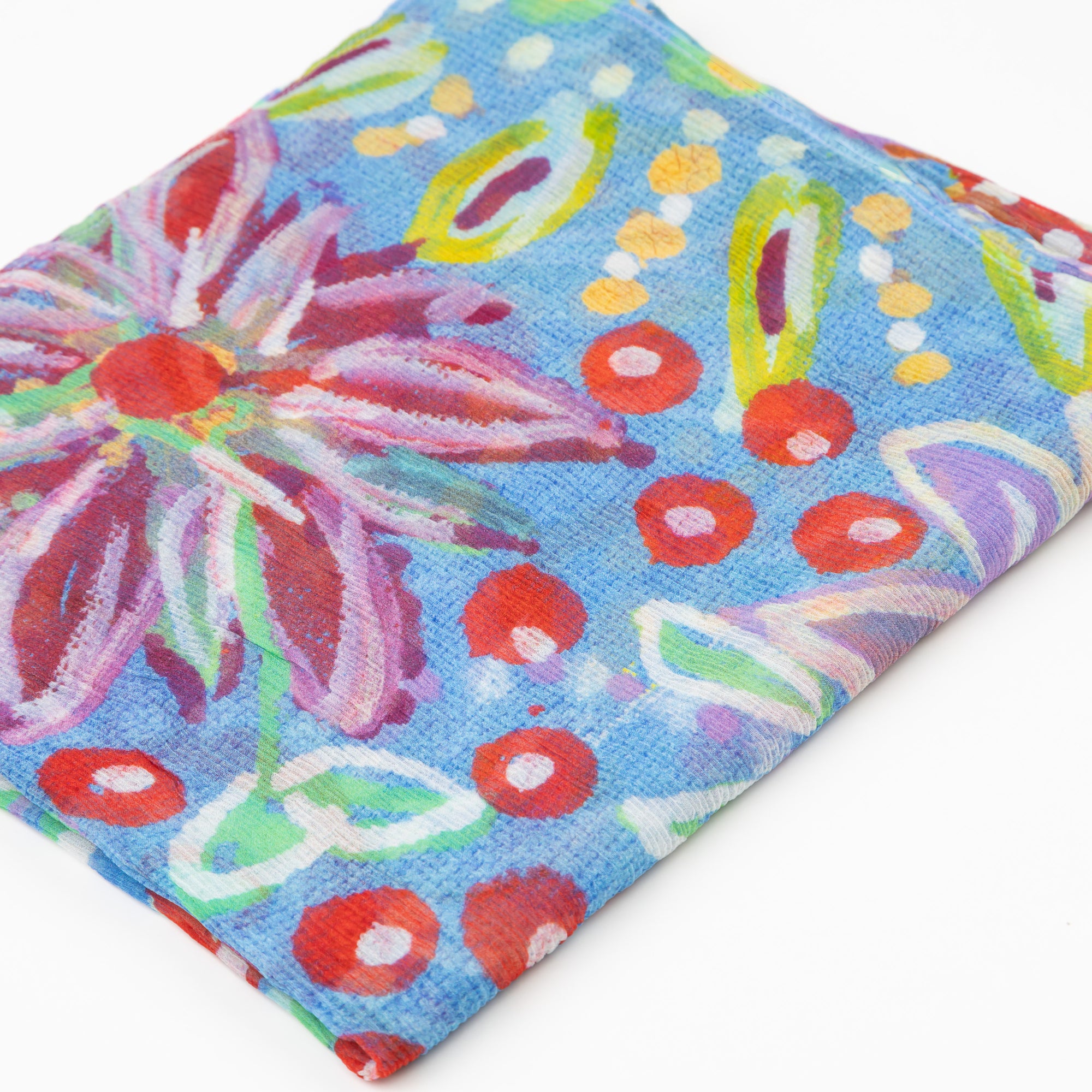 Close up of the folded luxury cashmere scarf with colorful Pilbara wildflower design by Sally White.