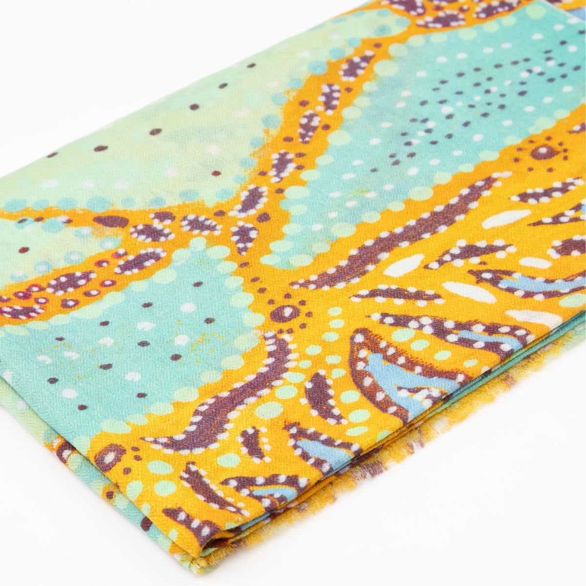 Close-up of folded Karijini 100% Cashmere Scarf displaying intricate dot patterns in yellow ochre, mint green, and purple inspired by Banjima Wirrlimarra country by artist Sally White.