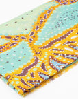 Close-up of folded Karijini 100% Cashmere Scarf displaying intricate dot patterns in yellow ochre, mint green, and purple inspired by Banjima Wirrlimarra country by artist Sally White.