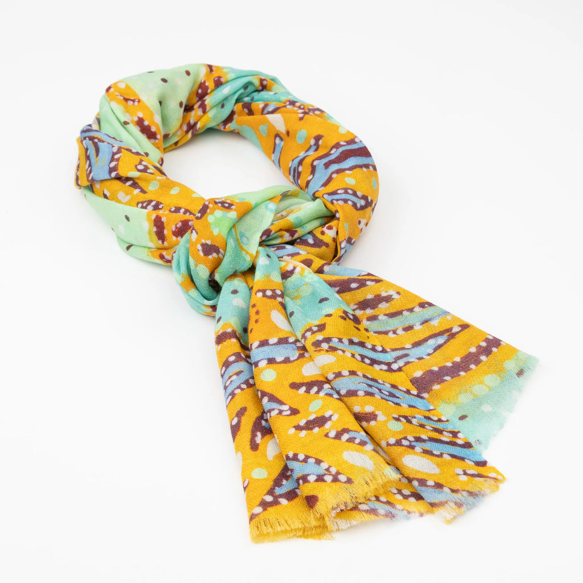 Kirrikin Karijini Luxury Cashmere Scarf styled in a loose knot, featuring vibrant yellow ochre, seafoam green, turquoise, and purple Indigenous artwork by Sally White.
