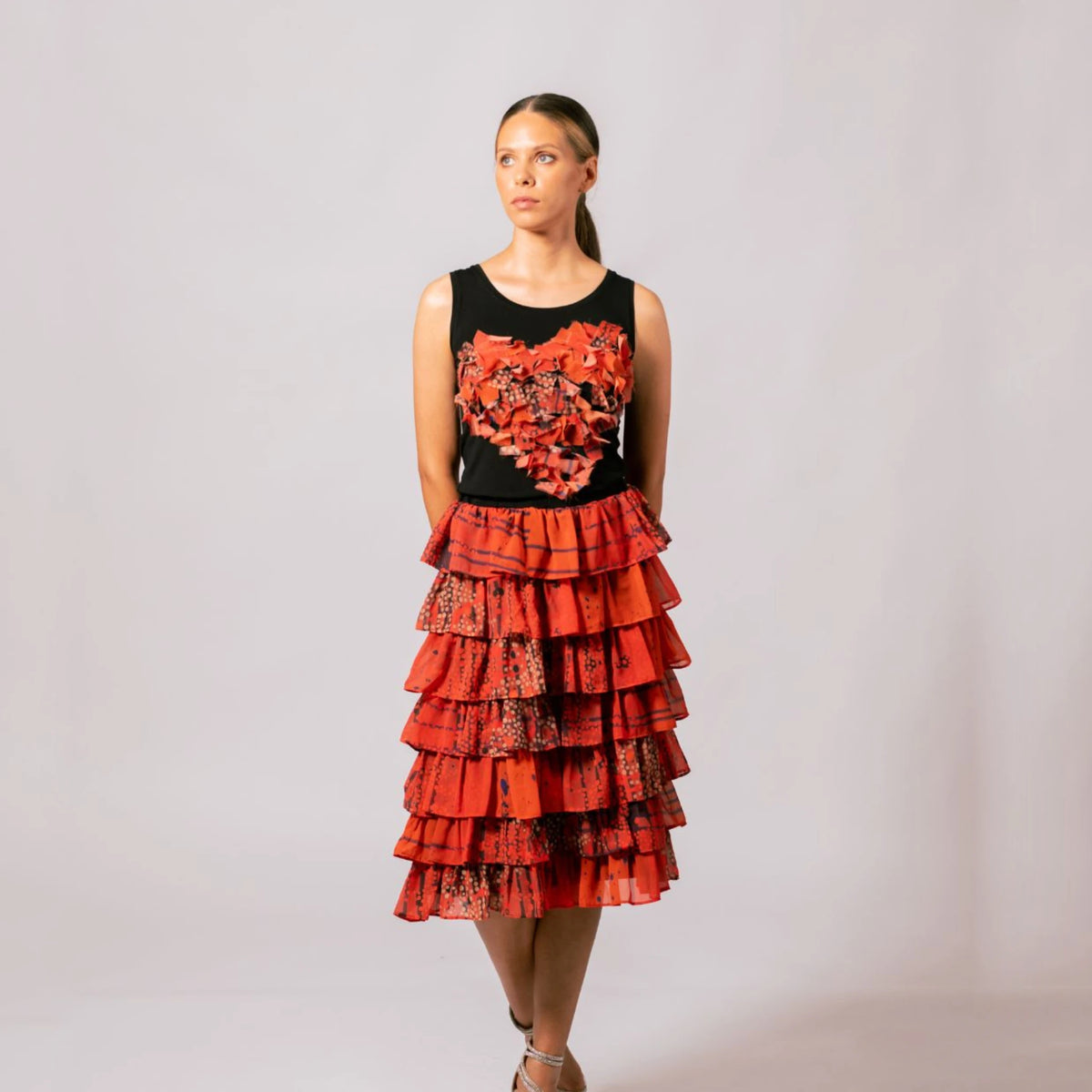 Front view of model wearing the black Lauren Heart Top featuring Overland Sigh heart applique by Emma Kerslake with a tiered ruffle skirt.