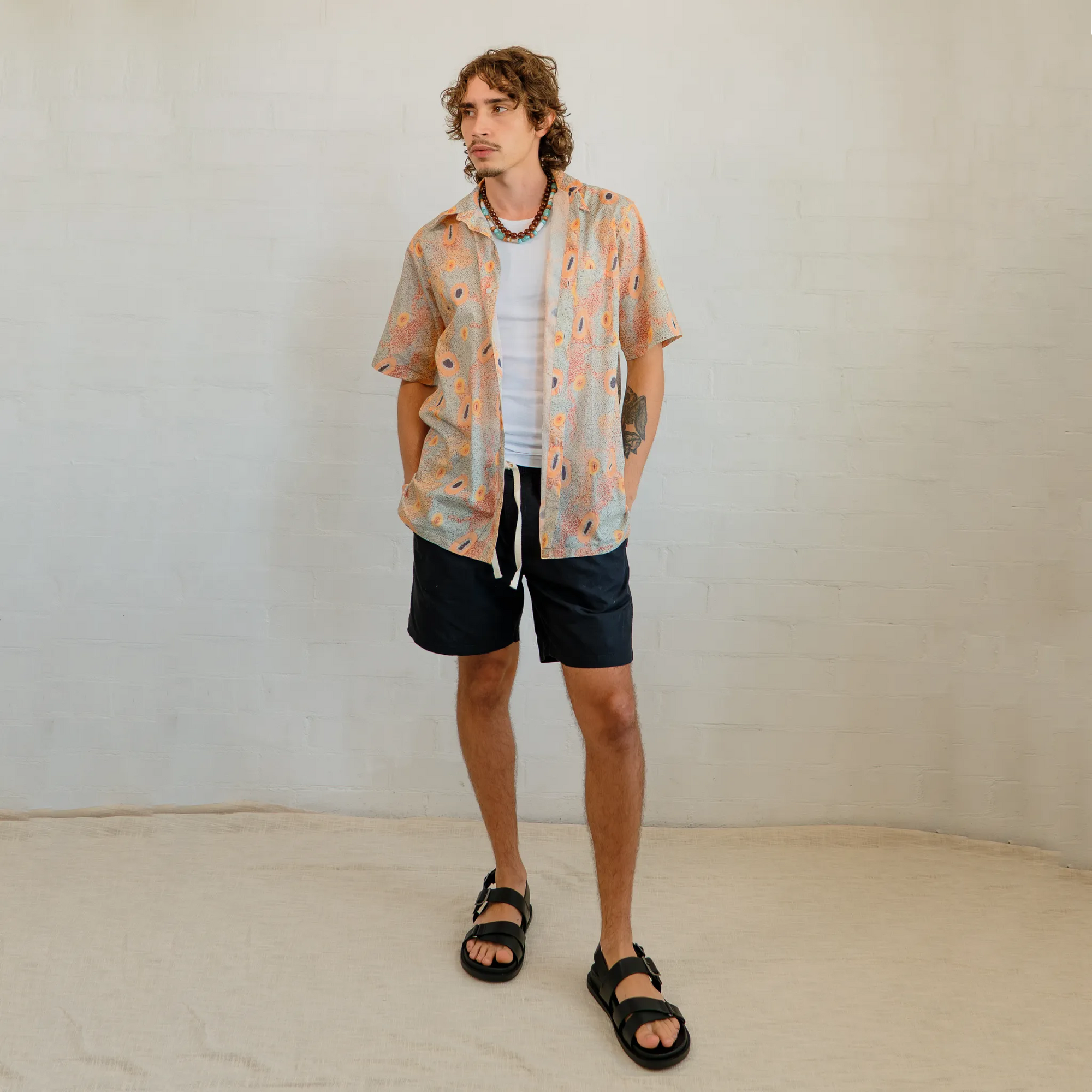 Breathable men's resort-style short sleeve shirt with original Aboriginal art pattern, designed by Kirrikin.