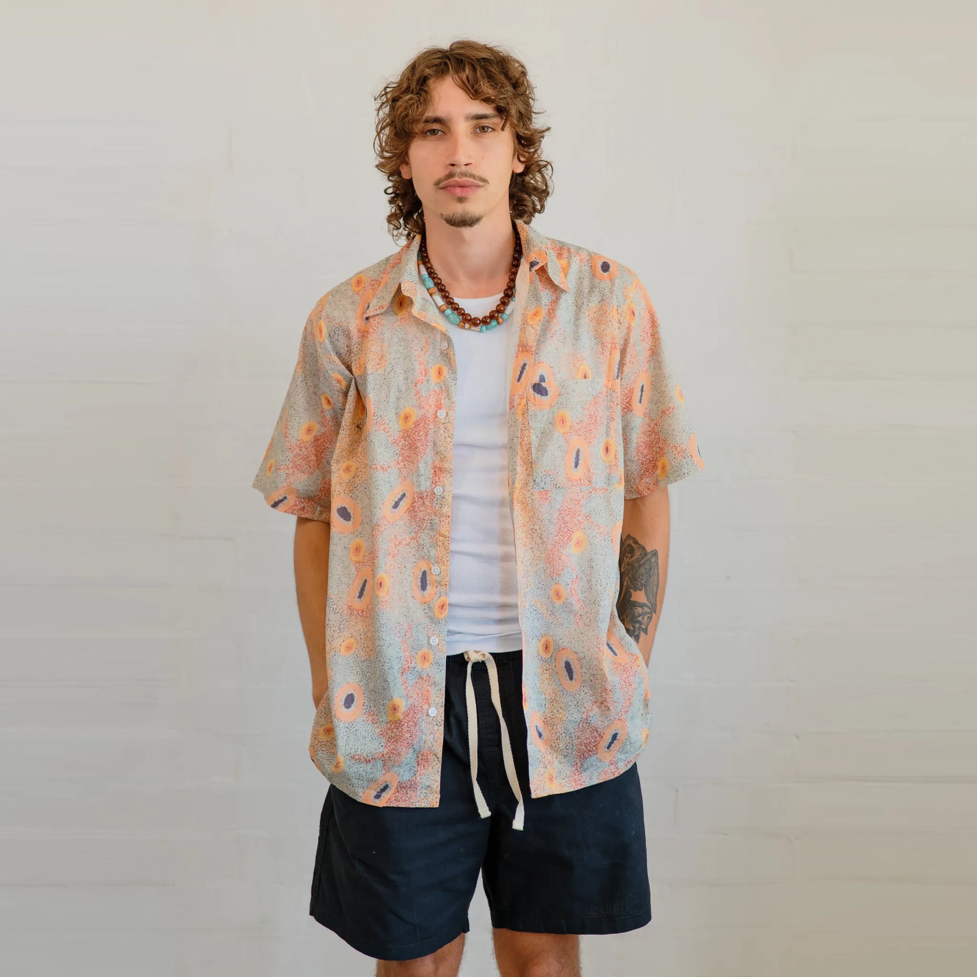 Detailed view of Sheryl Hicks' Indigenous Dry Country design printed on Kirrikin men's lightweight short sleeve shirt.