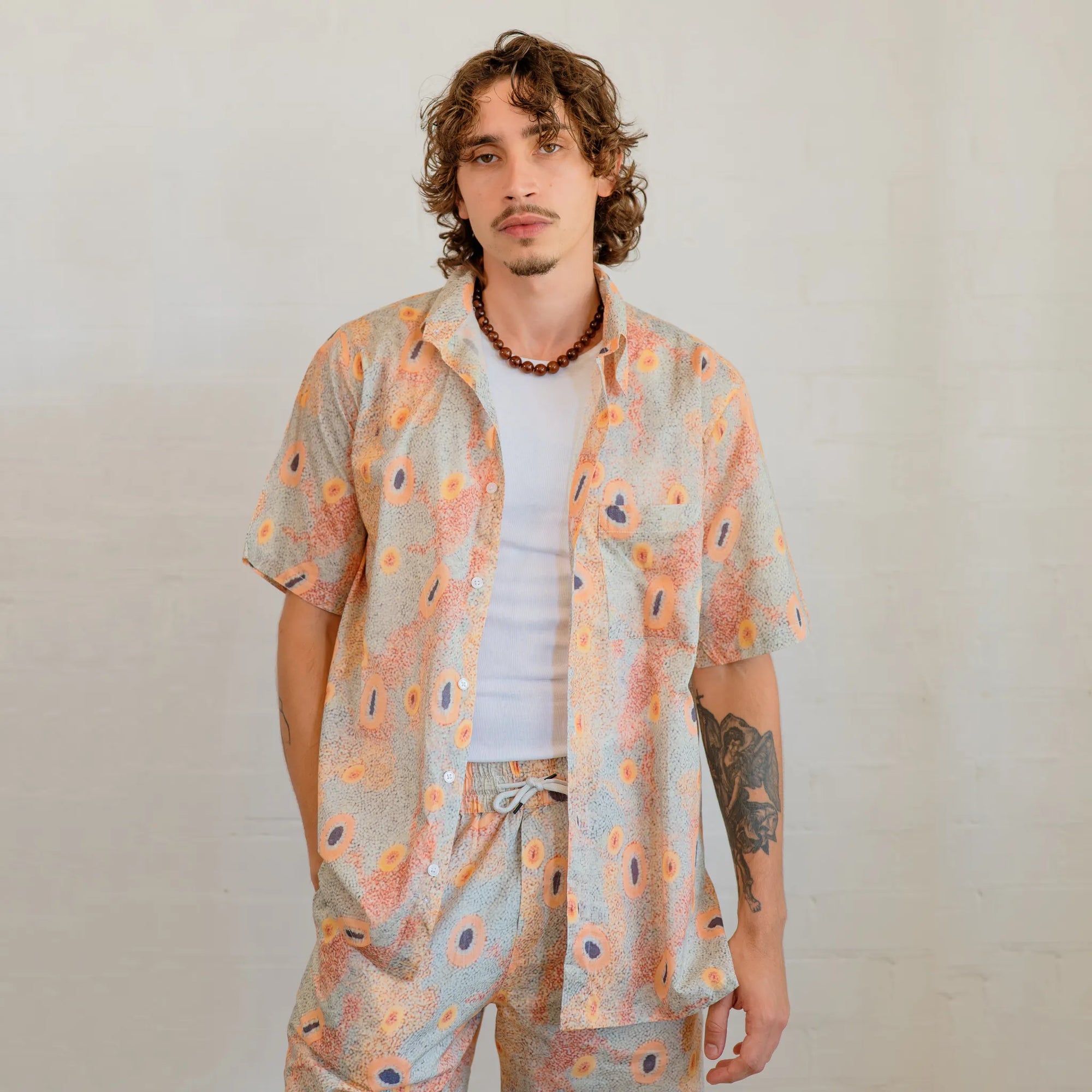 Close-up detail of Sheryl Hicks' Indigenous artwork printed on Kirrikin Men's Dry Country casual shorts.