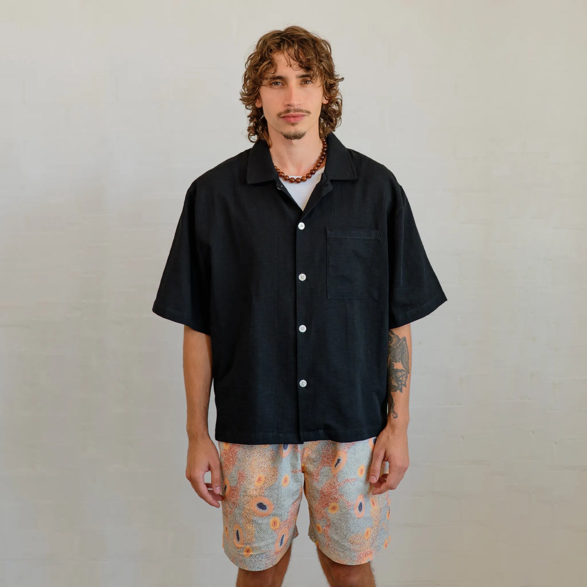 Men's Dry Country shorts featuring vibrant First Nations artwork by Sheryl Hicks, designed by Kirrikin.