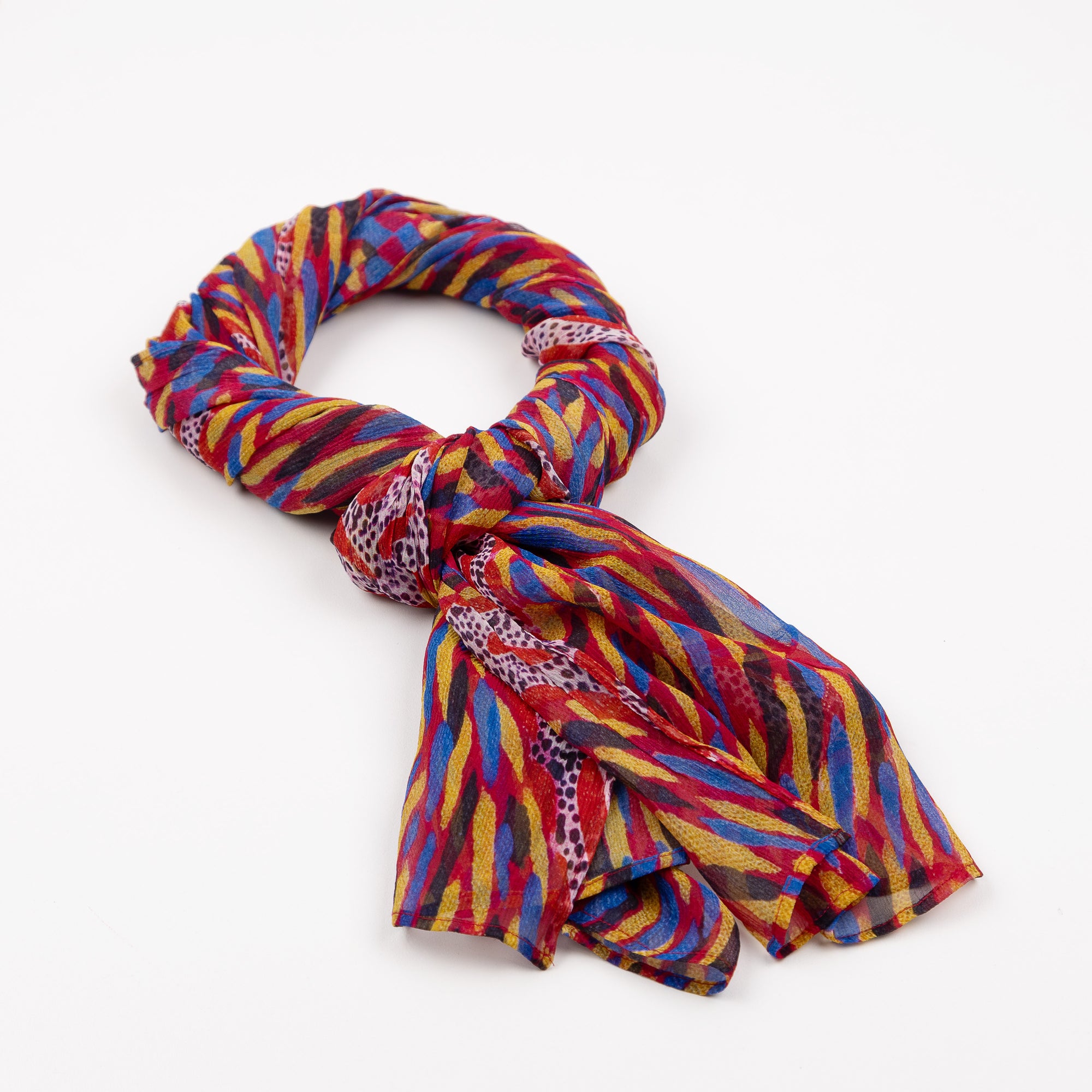 Storms in the Pilbara Silk Chiffon Scarf styled in a knot on a white background, showcasing colorful artwork by Kaye White.
