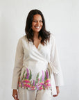 Front view of the Kirrikin Wrap Blouse in Princess Gum featuring soft pink Indigenous floral artwork